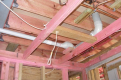 The upper floor kitchen toilet and bathroom pipe work tucks into the floor framing.