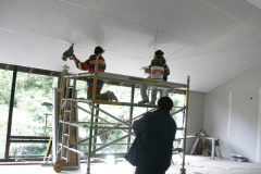 The high ceiling makes for quite a job of plastering the gib board.