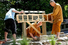 Teamwork ensures that the commemorative plaques are installed upright and level.