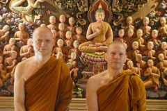 Ajahn Jayasaro and Ajahn Kusalo in front of one of the carved decorations in the new sala at Wat PahAmpawan.