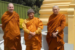 Ajahn Kusalo Chao Khun Maha Suthep and venerable Thitavijjo standing in front of the stupa at the Island Bay Monastery.