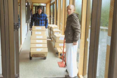 Cameron and Anagarika Colin making a start on moving the new shipment of books.