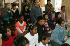 Children and adults alike listening to Ajahns explanation on the symbology of the Buddha rupa - prior to making lots of them.