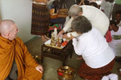The eldest Elder blessing the Buddhas in Palmerston North as part of the new year celebration.