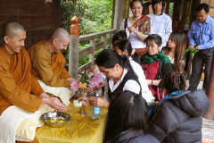 Ajahn Kusalo and Venerable Thitavijjo have their hands blessed - and again - and again. Awash with joy.