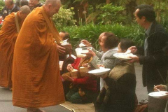 Offering alms to the Sangha.