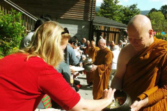 Ajahn Kalyano collects rice on pindapat.
