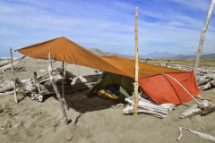 Cape Trip: Ajahn Kusalo opted for beach camping at Rangitukia. The hot sun required some creative robe adjustments.