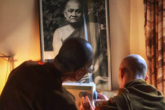 Ajahn Chah oversees a sewing demo.