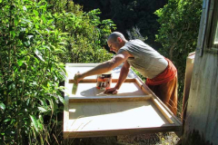Ajahn Kusalo painting the underside of the bed-thing for his new kuti (renovated triplex).