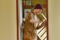 Venerable Hiriko applying finishing touches to the door of the renovated triplex.