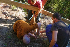 Ajahn fine tuning a brace on the new patio retaining wall.