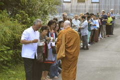 Ajahn Ariyasilo receiving rice at the end of the New Years day pindapat.