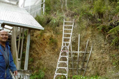 Vieng clearing the top of the bank at the upper house in preparation for the formation of the new patio area.