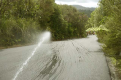 A cool hose on a hot carpark confirms the cross-fall grade into the drain.