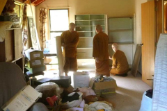 Stores from what is now the new office have moved to the back of the dhamma hall. To make room the monks sewing room left the dhamma hall and is here being reassembled in the upper house.
