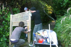 Three wise men working on the trellis out back of the sala built to give a more emphatic sense of privacy for the kuti.