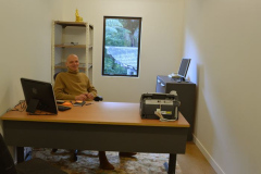 Venerable Aruno trying out the set up in the new office. It is still a bit bare but the basics are pretty much in place. The bell tower is visible in the back window.