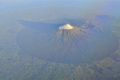 The full circular glory of Mt. Taranaki casts a long early morning shadow.