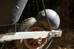Our wheelbarrow has had a hernia.