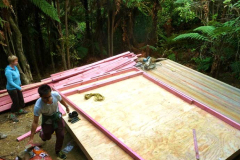 The new lower kuti about to get walls. Clare and Justine help to set out the frames.