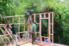 John fixing the finished walls together on the lower kuti with Craig and Justin lending a steady hand.