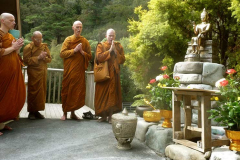 The sangha chants auspicious verses to bless the new buddha rupa.