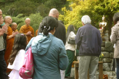 Everyone pours a little water on the new rupa to offer their blessing.