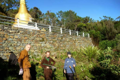 The trees obscuring the stupa have been trimmed. We will try and keep them better hedged.