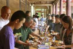 The community shares the Magha puja meal.