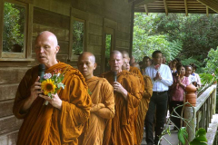 Ajahn Sucitto leads the sangha and the laity in a circumambulation of the sala.