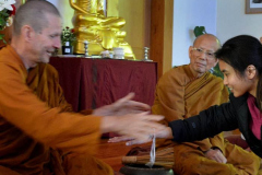 Ajahn Kusalo gives a blessed thread to Eve.