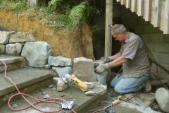 Simon carefully placing a corner stone at the bottom of the stairs.
