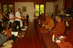 Simon and members of the monastery committee carry the Kathina-season cloth forward to present to the Sangha.