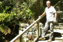Simon here in his role as stonemason getting underway to finish the wall alongside the stairs up to the carpark.