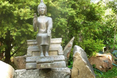The Buddha patiently waits outside the dana sala - both to be polished and to have a finished stone plinth to sit on.