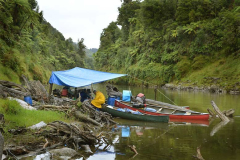 Cyclone Pam mostly passed us by but we had rain on the 17th and took lunch on a small gravel beach. Large driftwood logs gave fixing points to rig a roof.