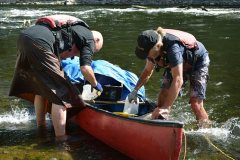 There are no photos of us shooting the rapids. This shot is post-submersion. Get the canoe upright and empty out the water.