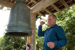 Simon rings the bell to invite everyone to assemble in the hall.