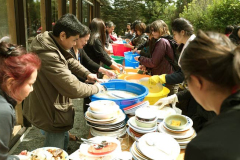 Many hands help with the washing up after our shared meal.