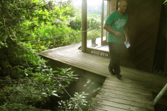 The hermitage kuti will get an upgrade before winter. Extended safer deck + wood stove. Bruce taking a few measurements.
