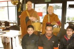 Two lads (front L&R) spend holiday time at the monastery and join the monks for pindapat in Stokes Valley.