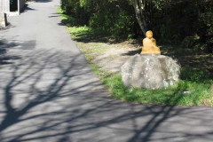 The rock at the edge of the lower carpark - with Buddha.