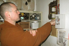 Venerable Issaro working his magic with final touches to the new dormitory wiring.