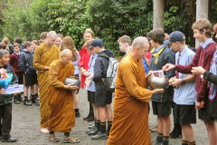 Fifty students from Kapiti College offer alms to the sangha as part of their recent visit.