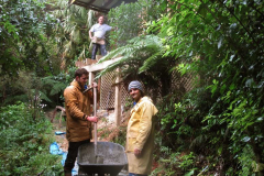 James and Daniel mixing concrete for the deck support foundations as part of the Chao Khun kuti renovation. Bruce watches from above.