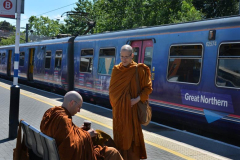 Ajahn Cunda (with coffee) and venerable Tithapunyo ready to board the train.