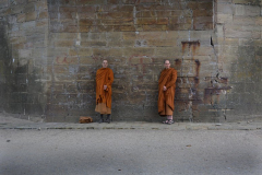 Two monks under a bridge.