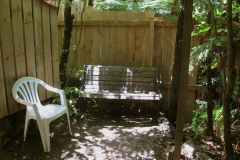 A new screen fence for the old sauna. Bench and chair sun and shade.