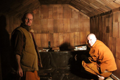 Ajahn Narado and venerable Kondanyo stripping out the rot and rubbish in the old sauna.